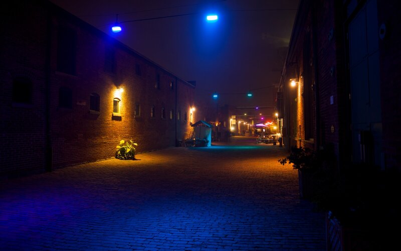 nighttime alley with blue lights