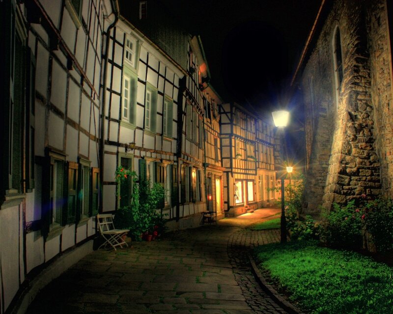 nighttime alley with half-timbered houses