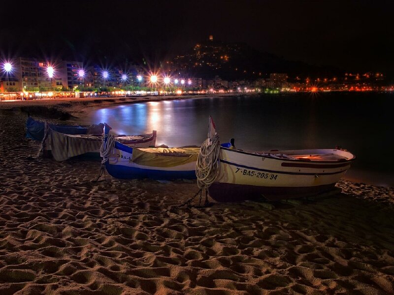 Nighttime beach with boats