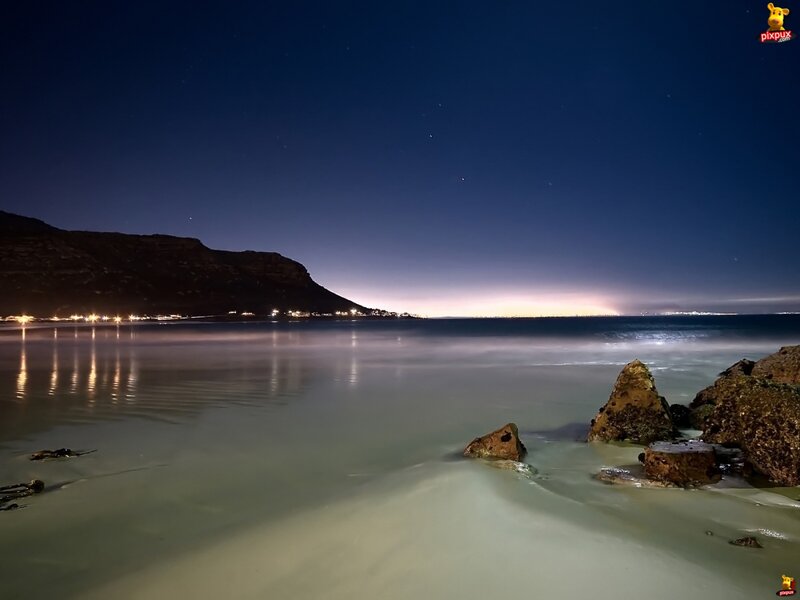 Nighttime Beach with Rocks — Blue
