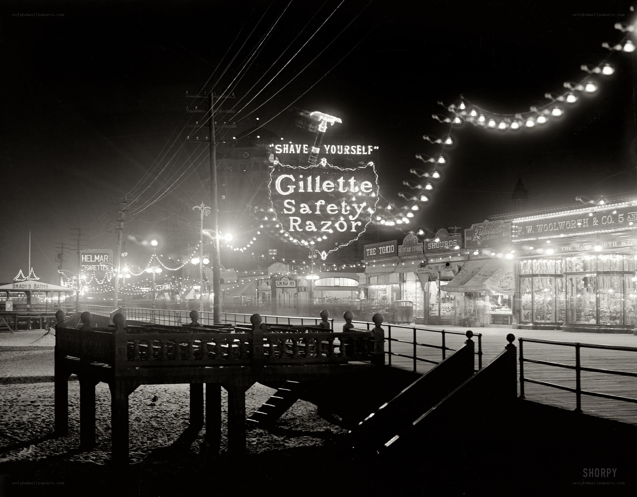 Nighttime boardwalk with neon signs