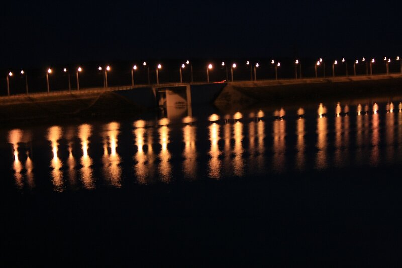 nighttime bridge lights reflection
