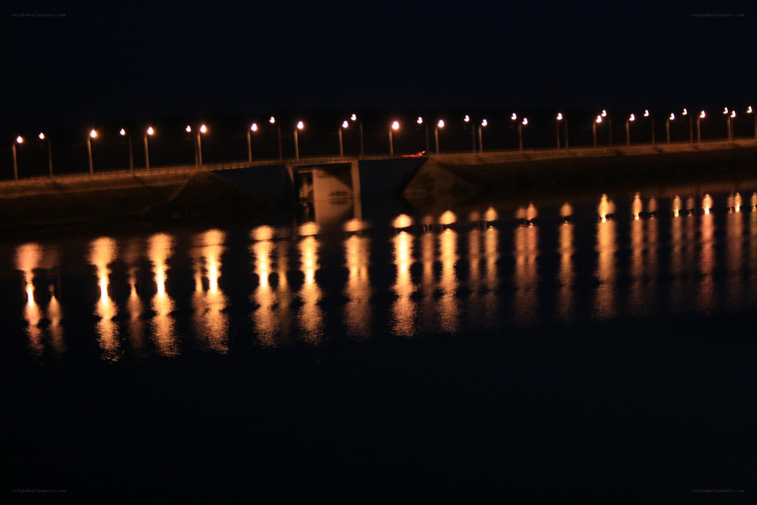 nighttime bridge lights reflection