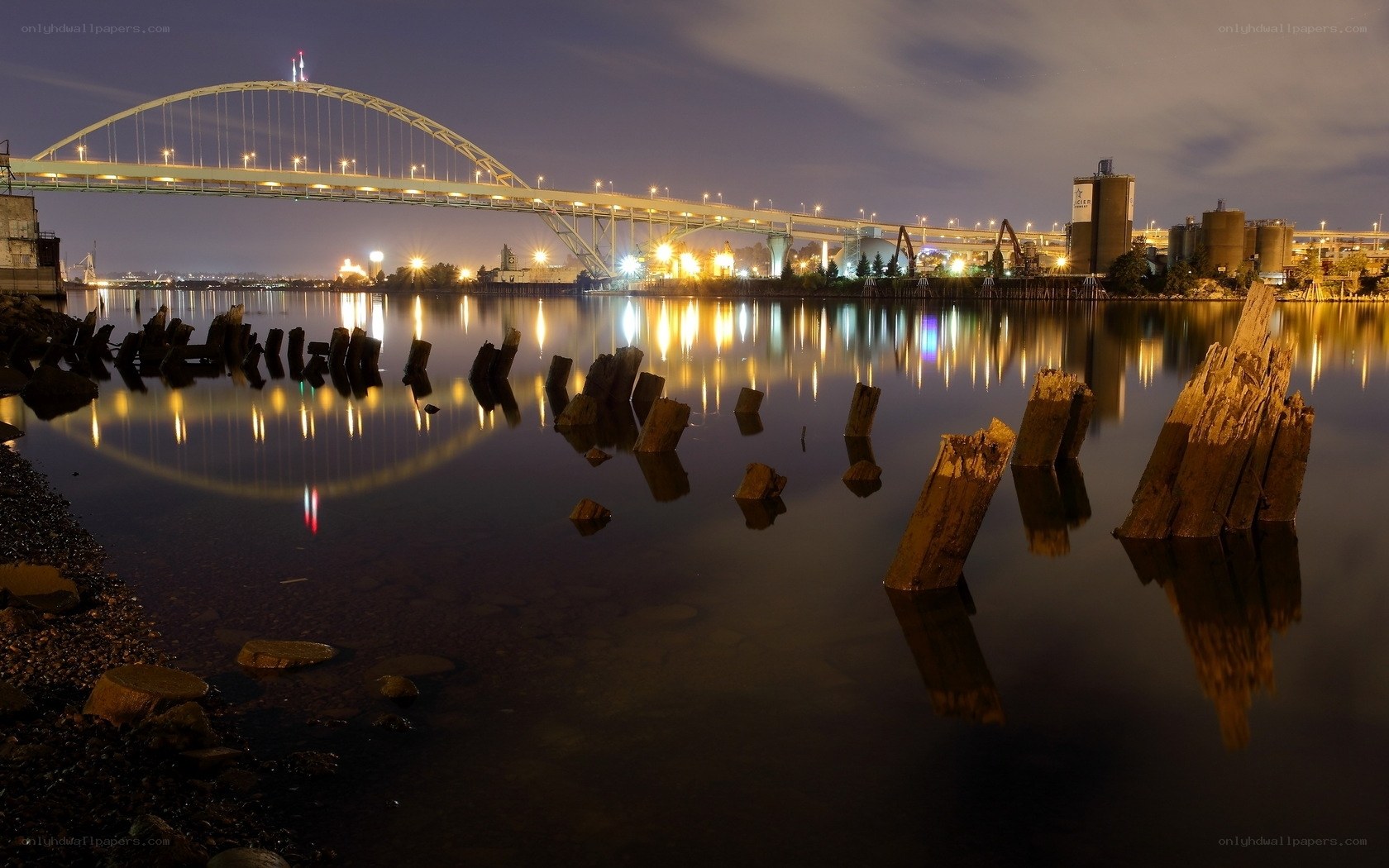 Nighttime bridge over calm water
