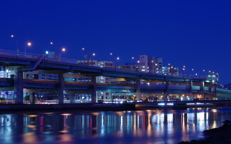 Nighttime Bridge over River — Blue