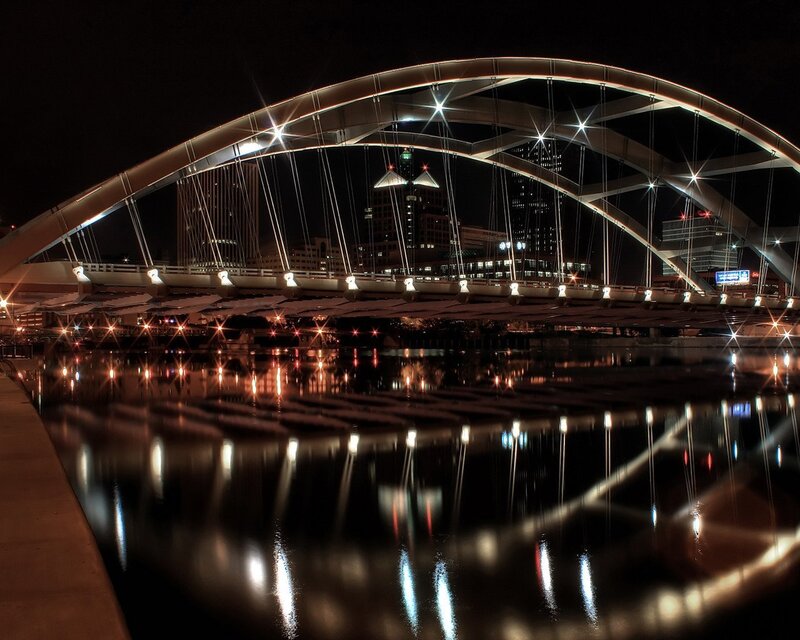Nighttime bridge with city lights