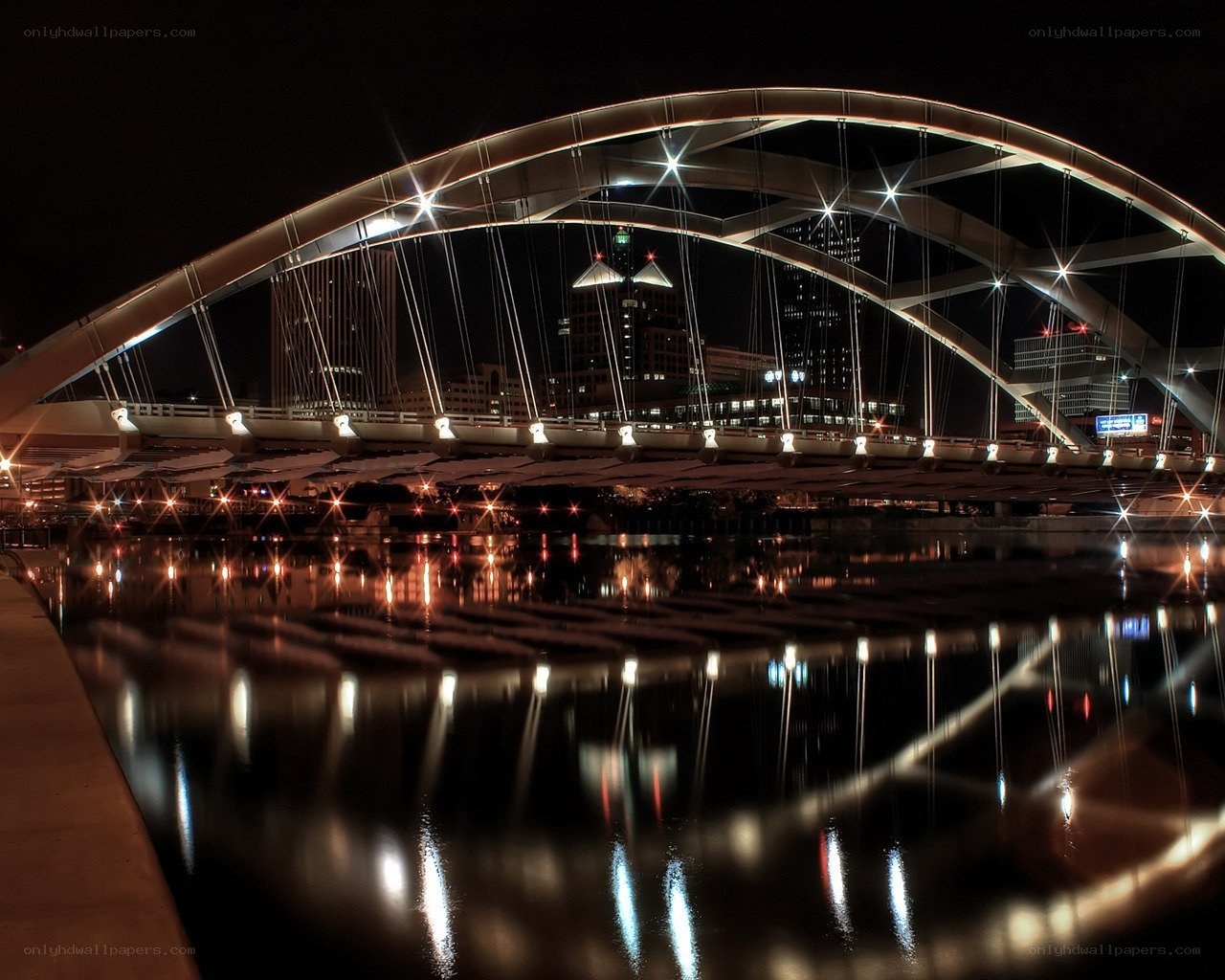 Nighttime bridge with city lights