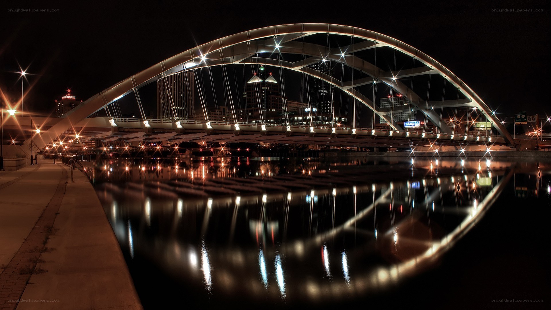Nighttime bridge with city lights