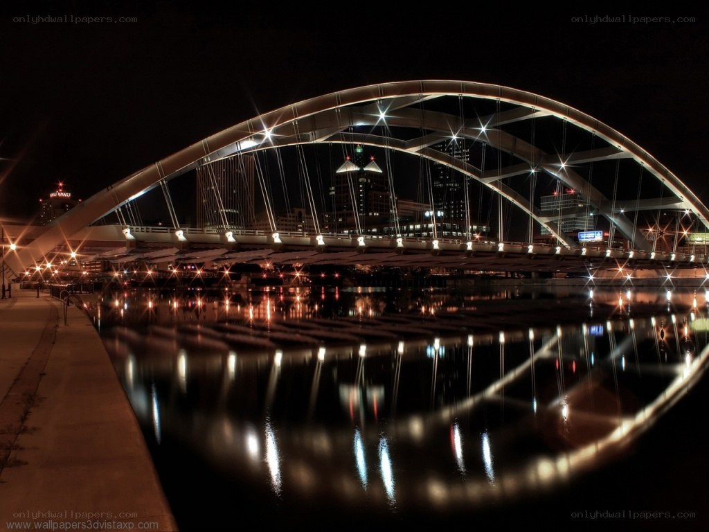 nighttime bridge with city lights