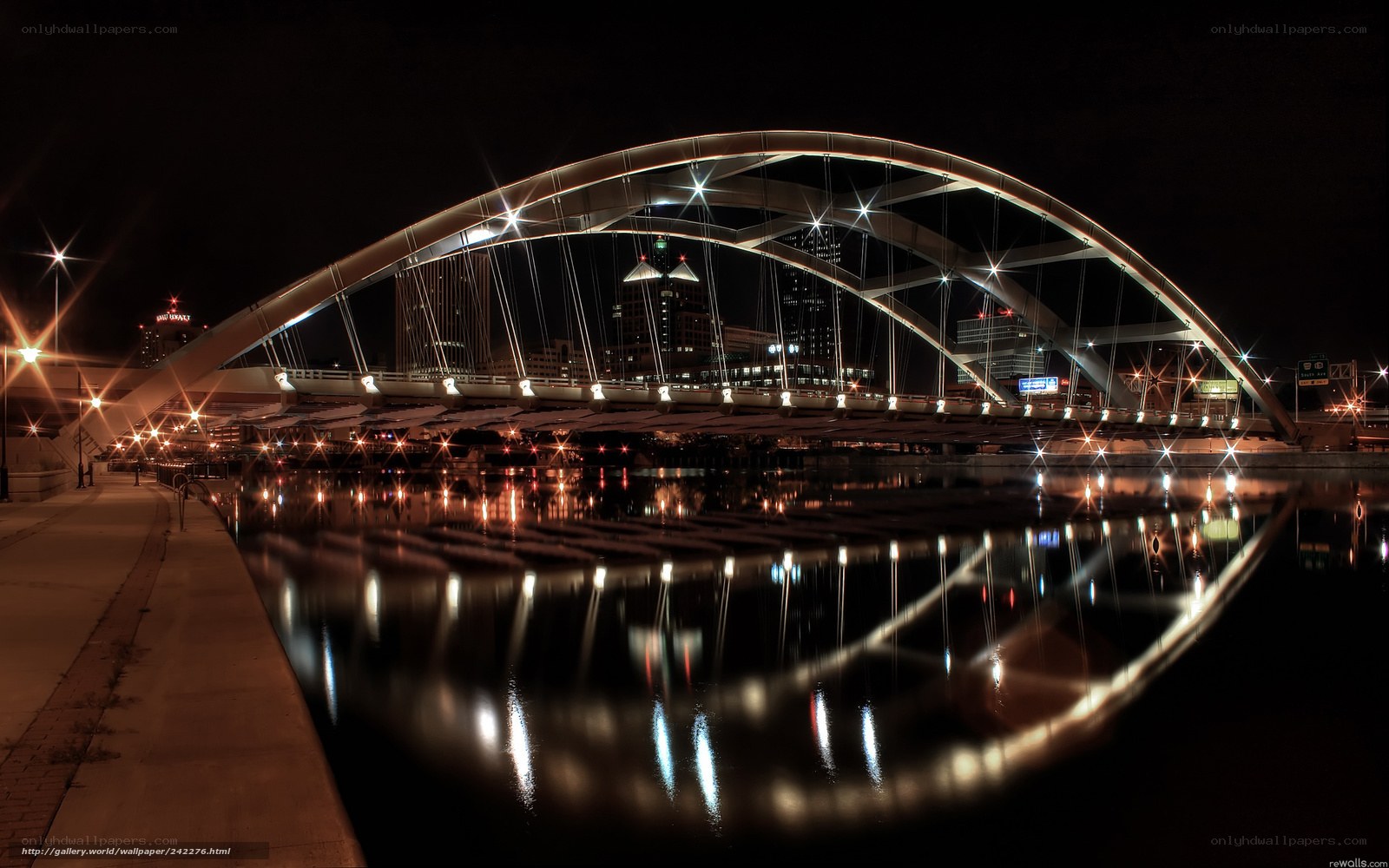 Nighttime bridge with city lights