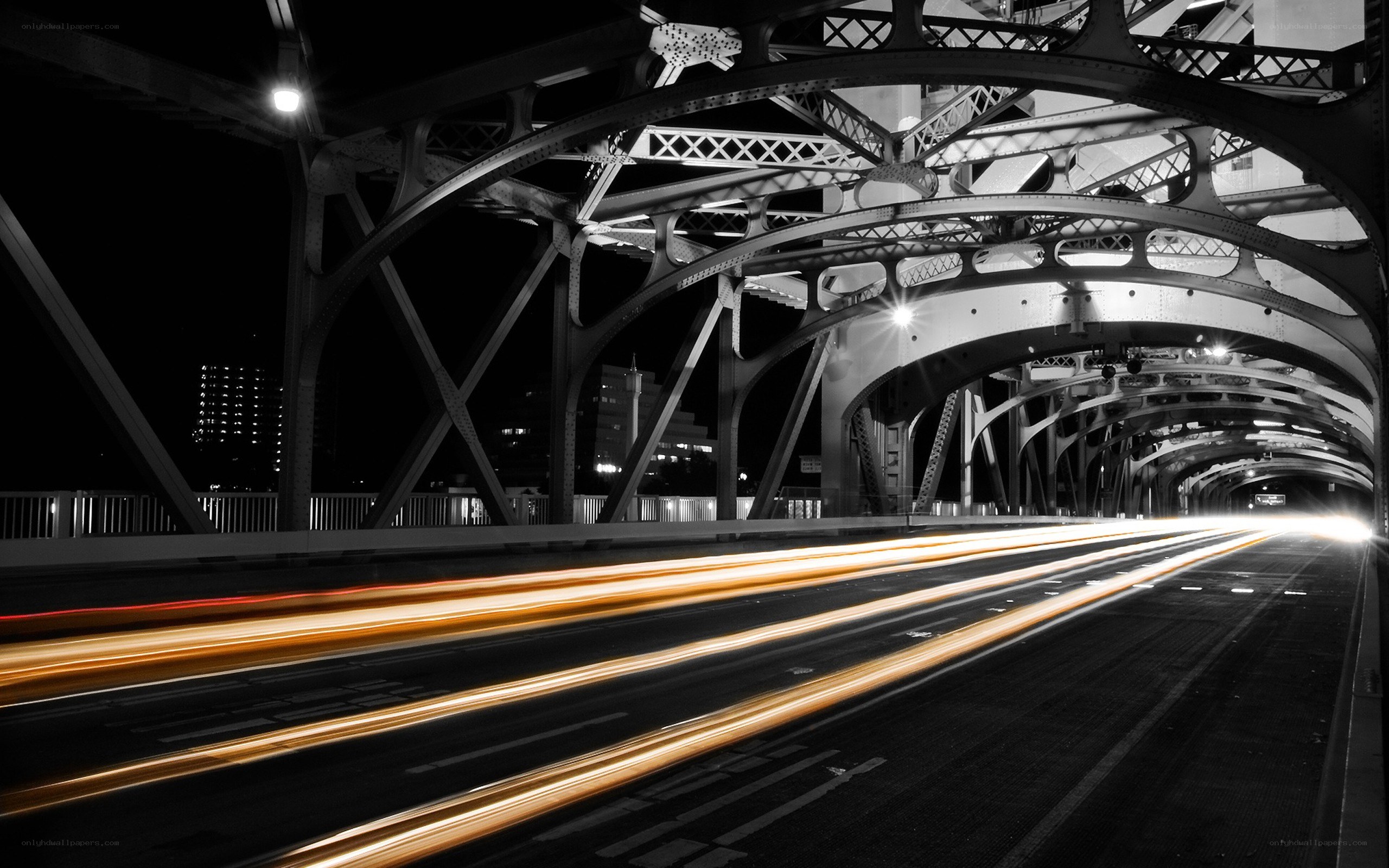Nighttime bridge with light trails