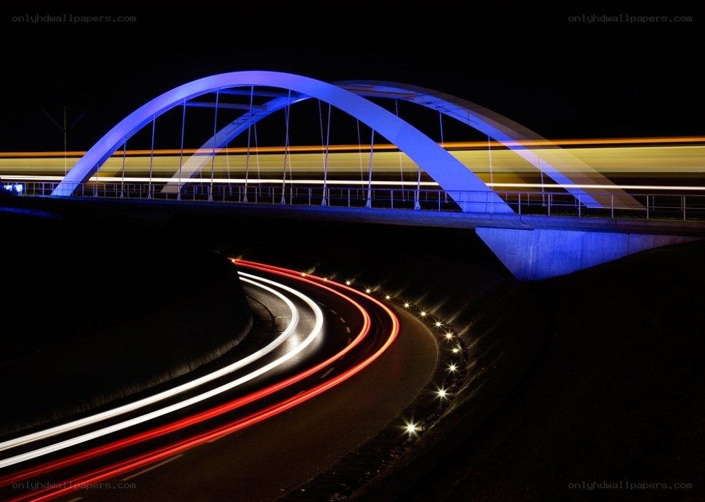 Nighttime bridge with light trails