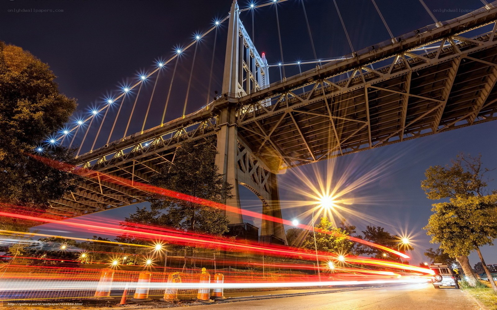 Nighttime bridge with light trails