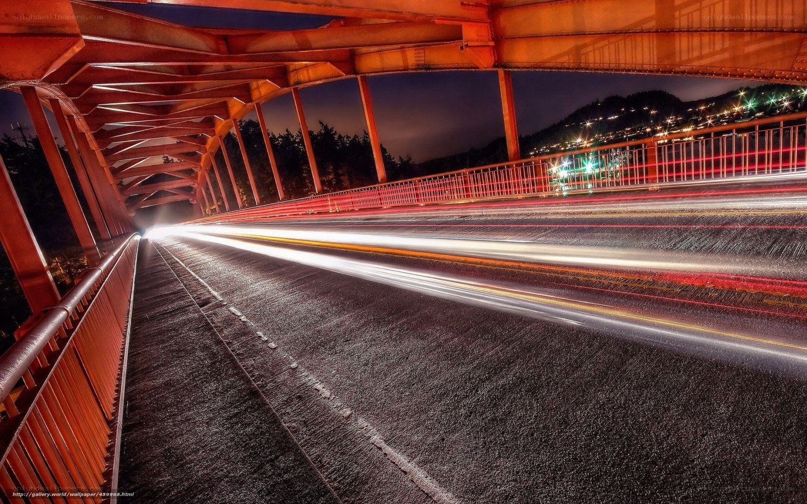 Nighttime bridge with light trails