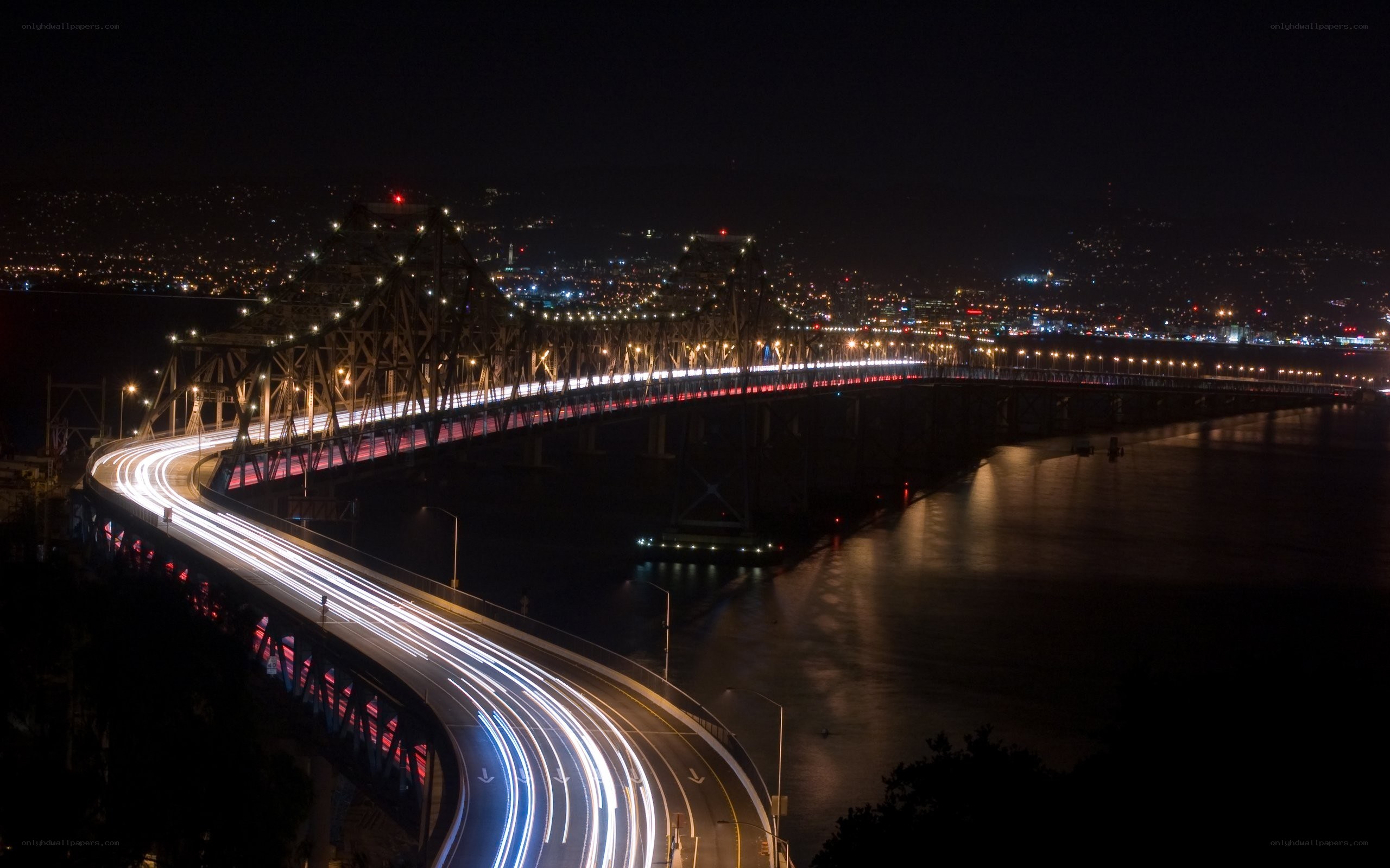 Nighttime bridge with light trails