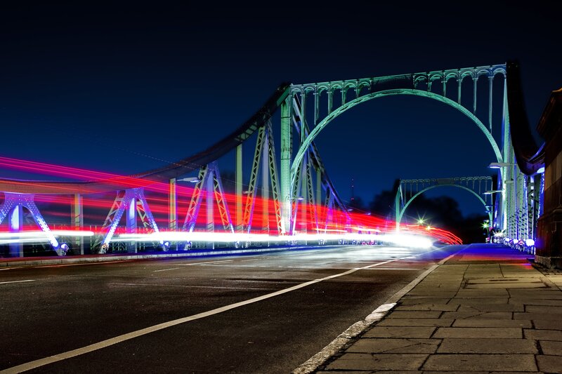 Nighttime bridge with light trails