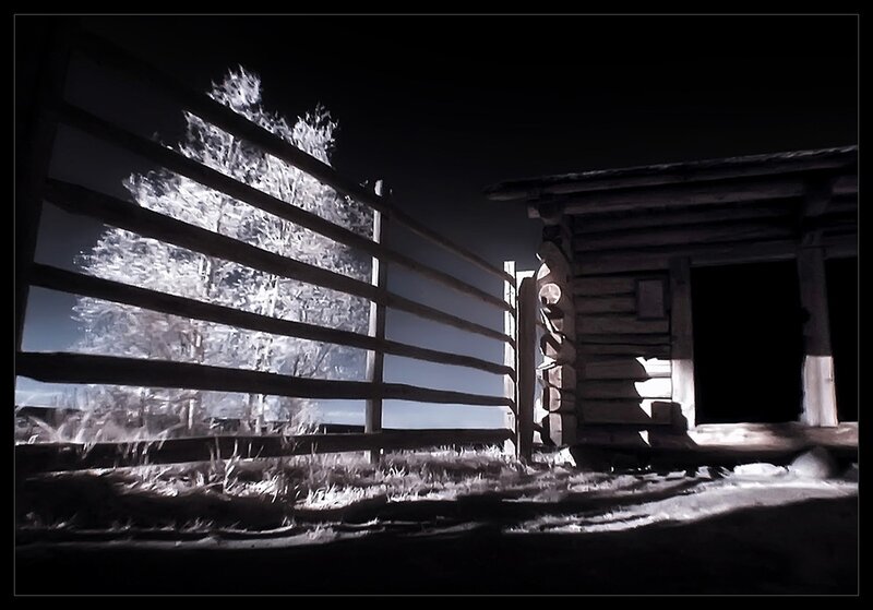 nighttime cabin with fence