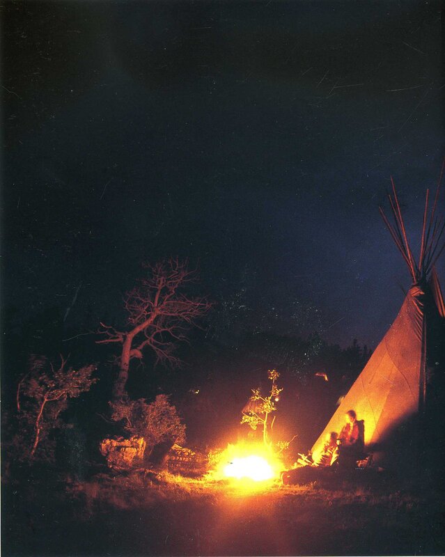 Nighttime campfire by teepee