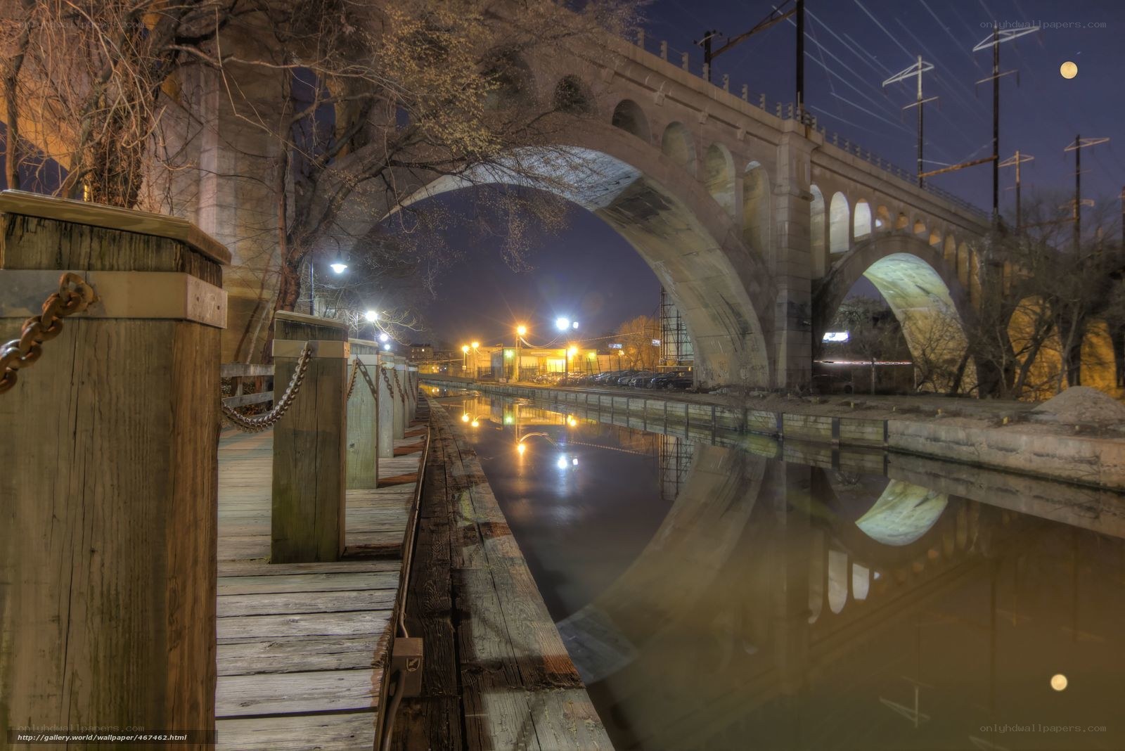 Nighttime canal under stone bridge
