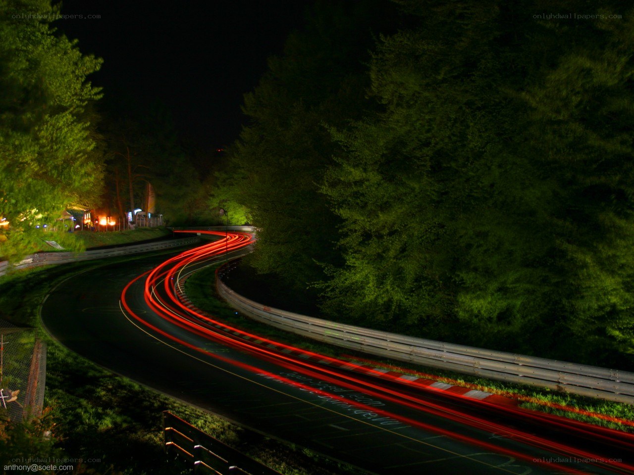 Nighttime car lights on a winding road