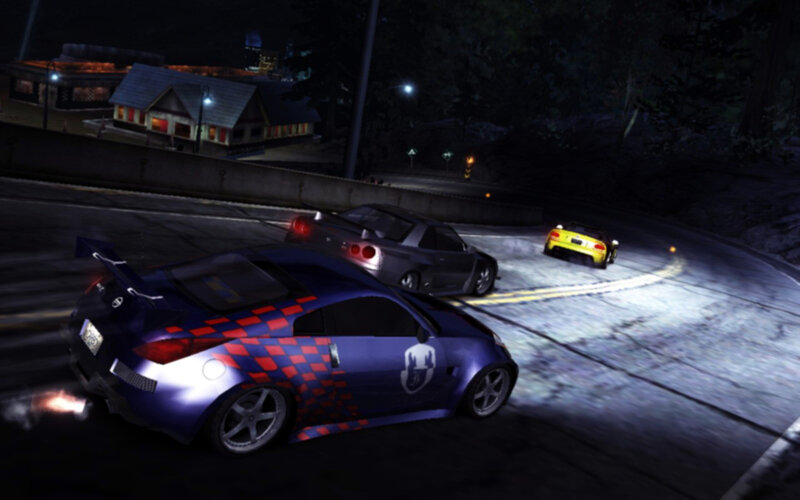 Nighttime car race on winding road