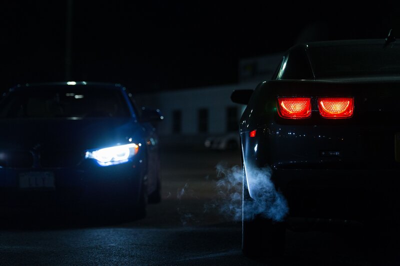 Nighttime car scene with exhaust