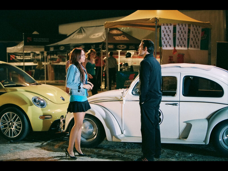 Nighttime car show conversation