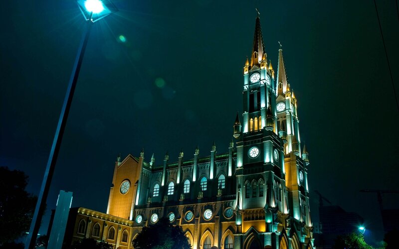 nighttime church with illuminated spires