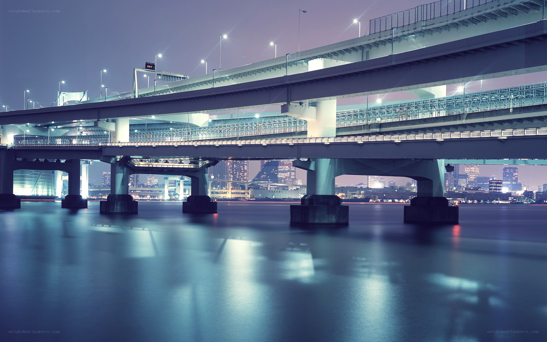 Nighttime city bridge over water