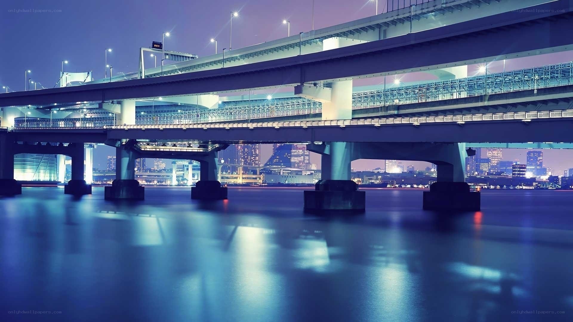 Nighttime city bridge over water