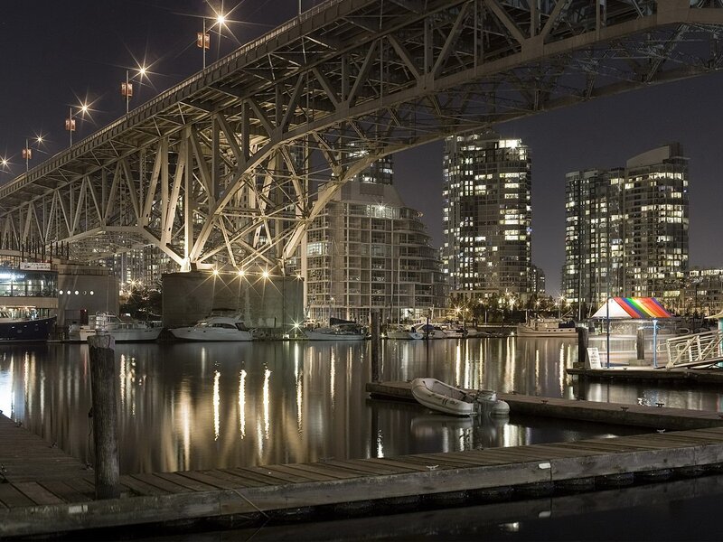 Nighttime city harbor under bridge