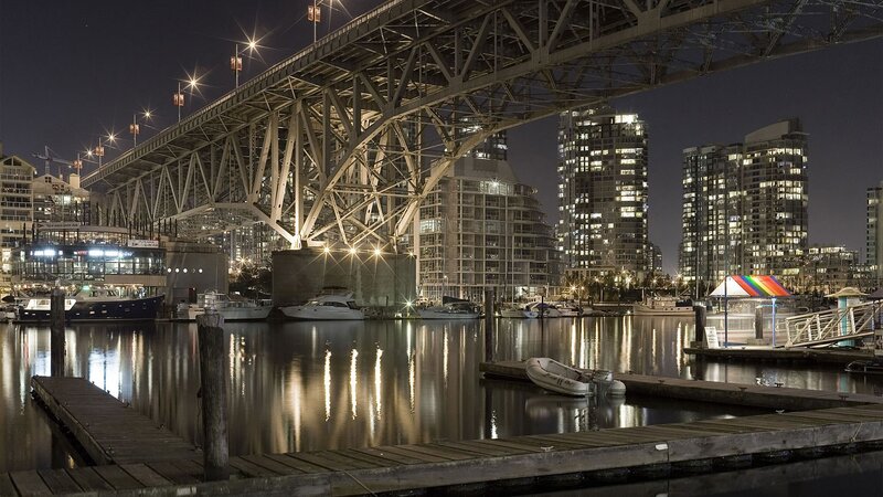 Nighttime city harbor with bridge