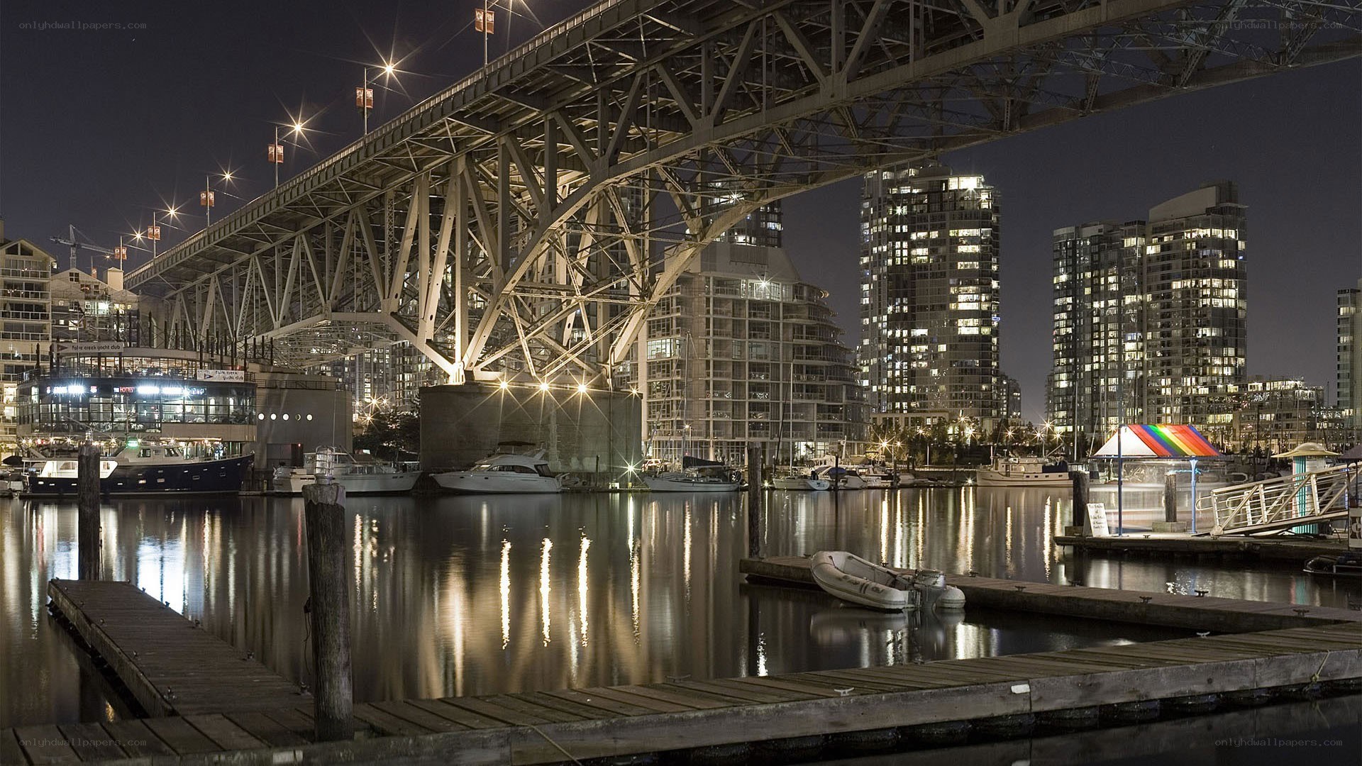 Nighttime city harbor with bridge