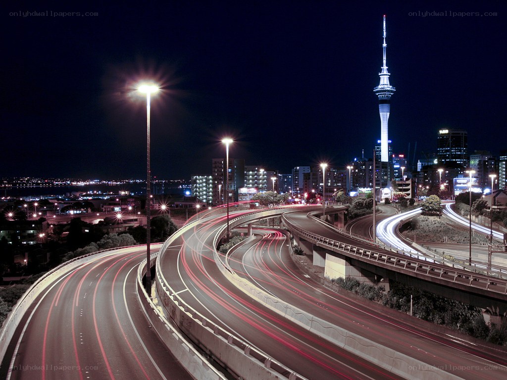 Nighttime city highway with tower