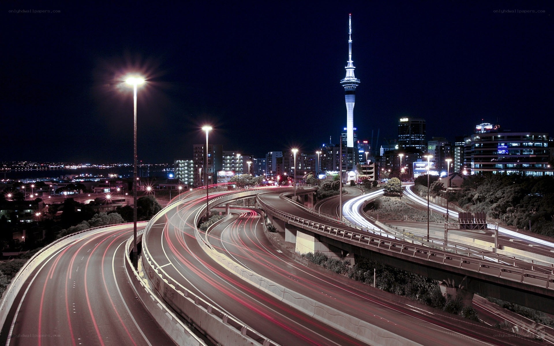 Nighttime city highway with tower