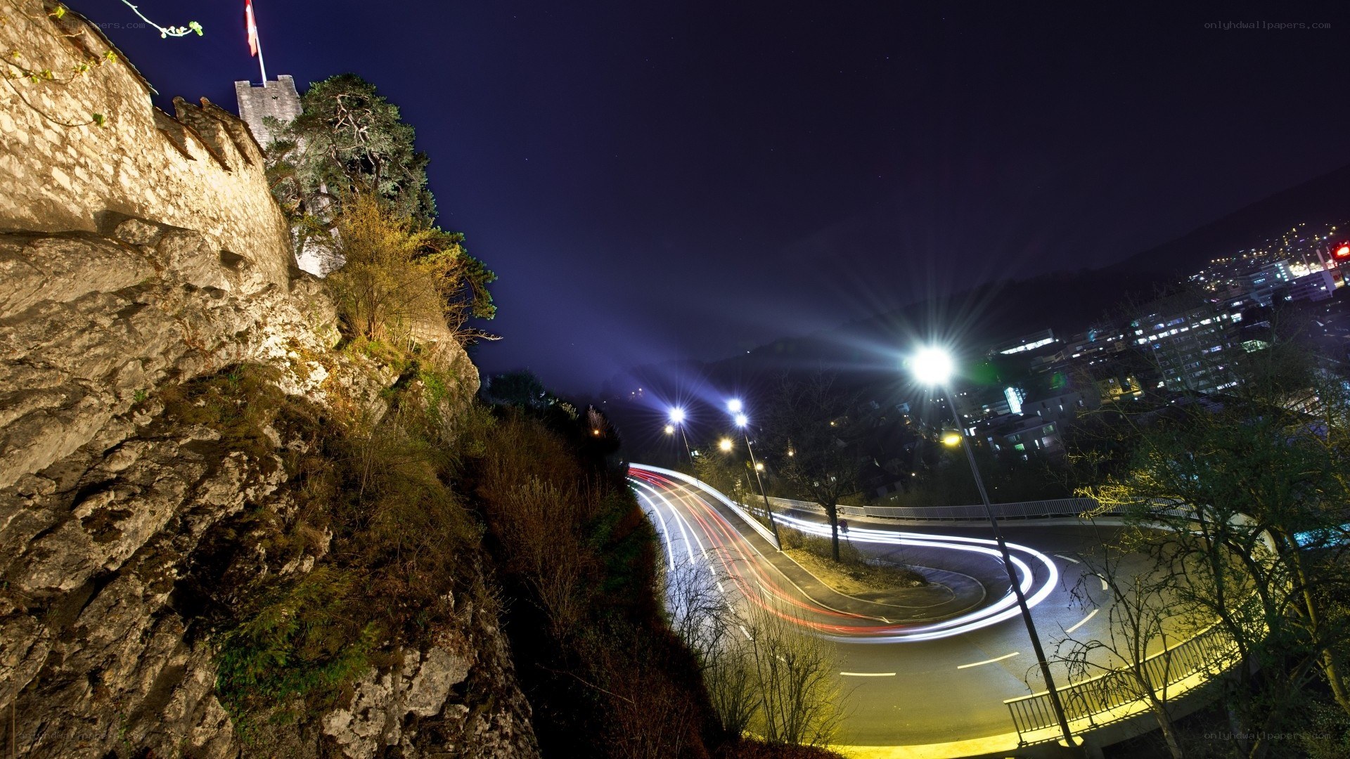 Nighttime city lights and castle