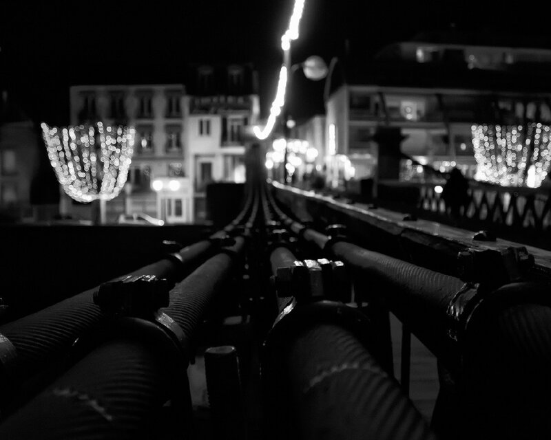 nighttime city lights and pipes