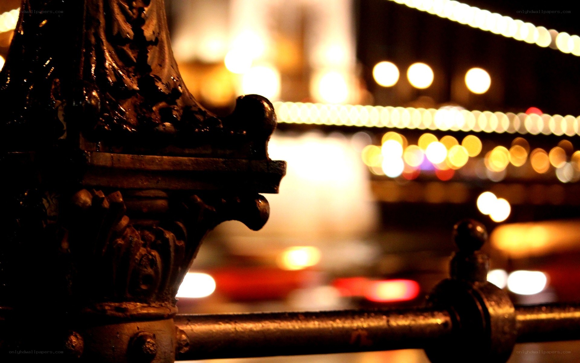 nighttime city lights and railing