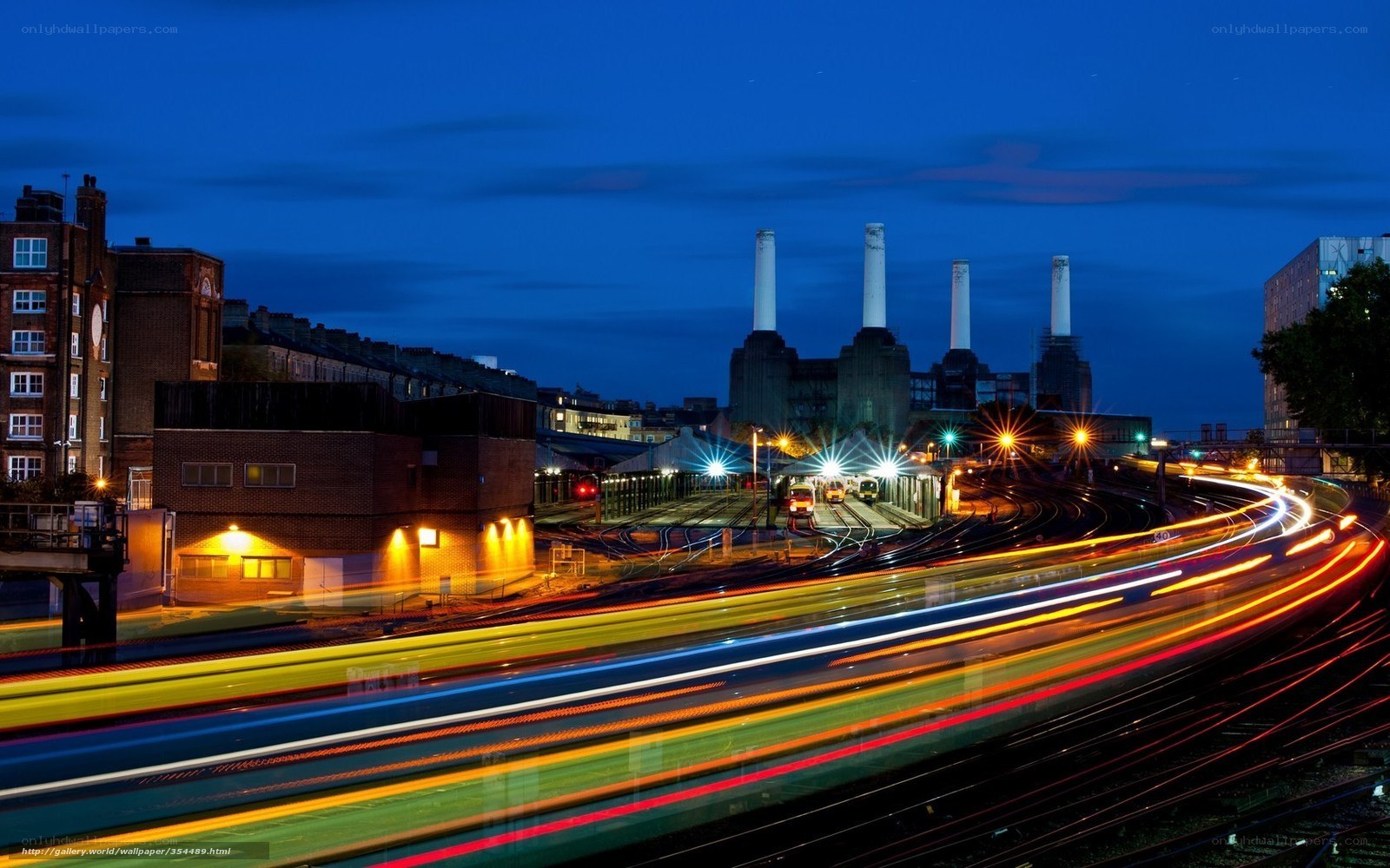 Nighttime city lights and train tracks