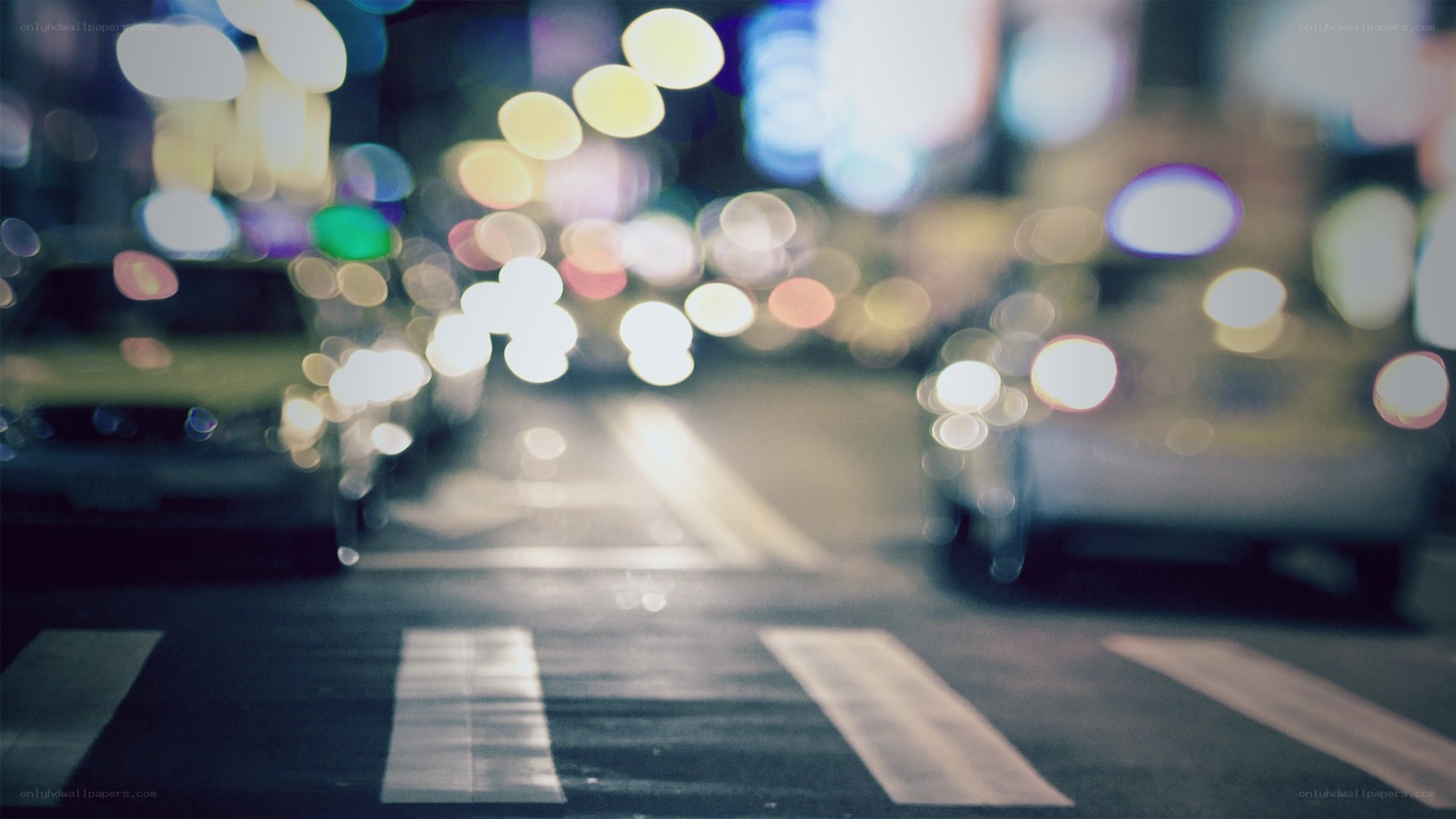 nighttime city lights at crosswalk