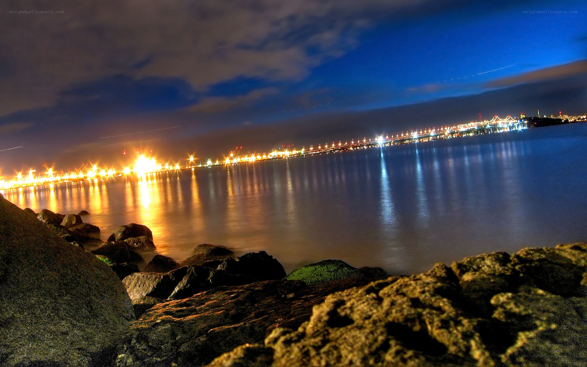 nighttime city lights over water
