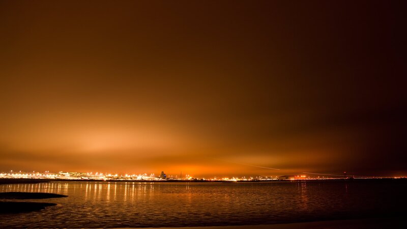 nighttime city lights over water
