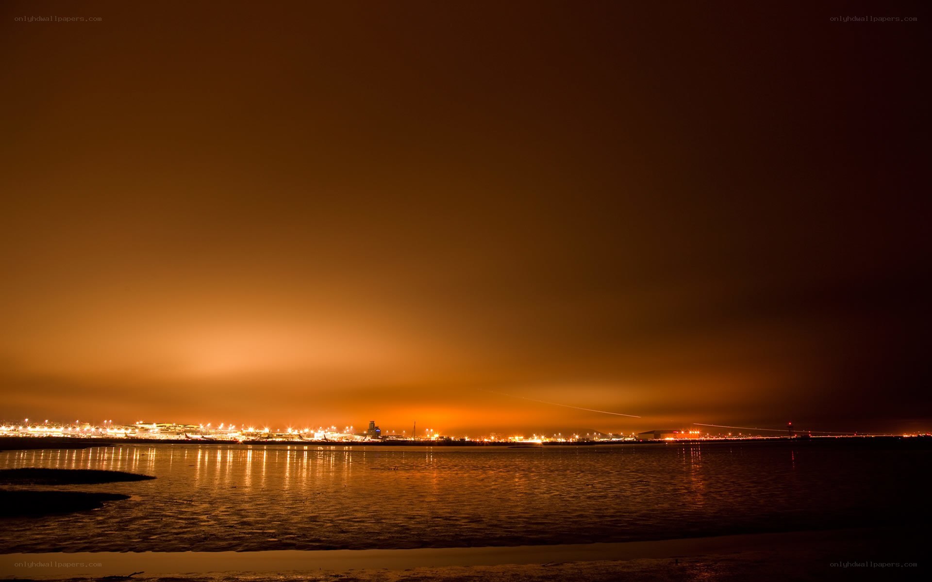 nighttime city lights over water