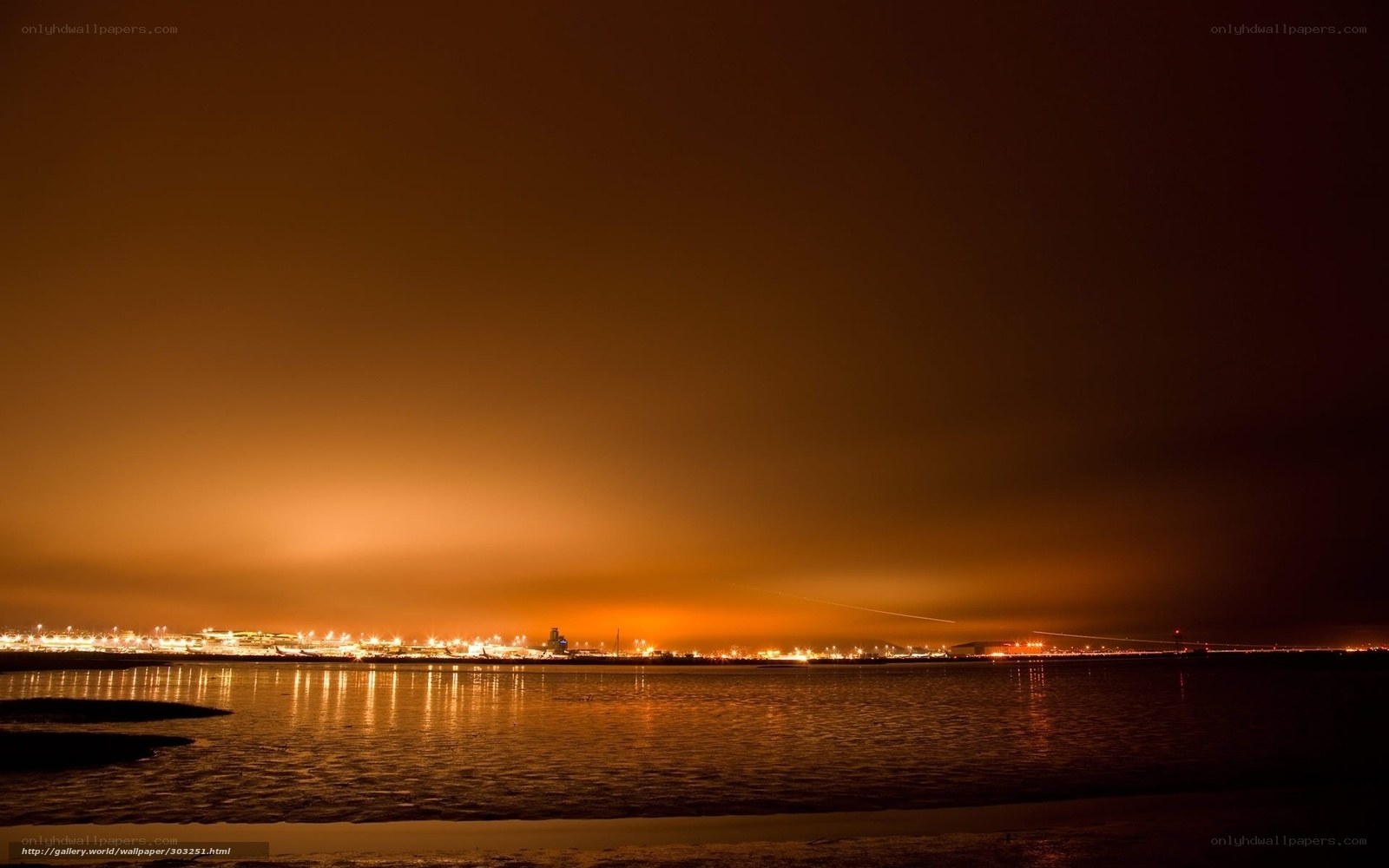 nighttime city lights over water