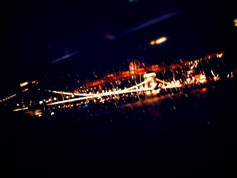 nighttime city lights through rain