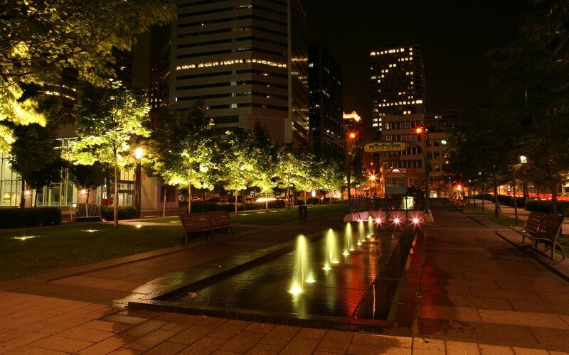 Nighttime city park with fountain