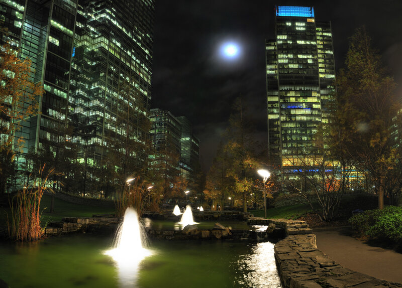 Nighttime city park with fountains