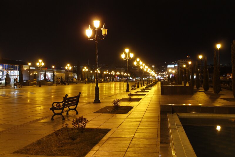 Nighttime city plaza with lamps