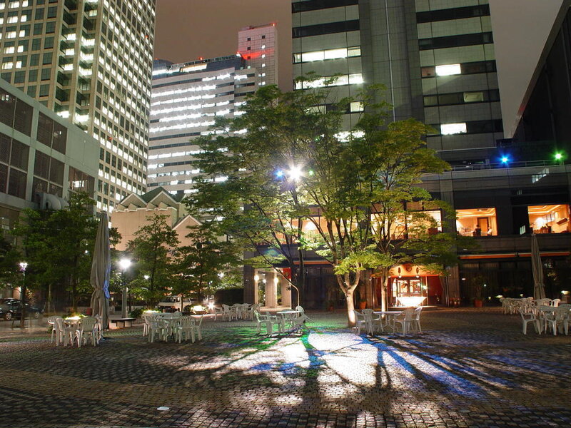 Nighttime city plaza with trees