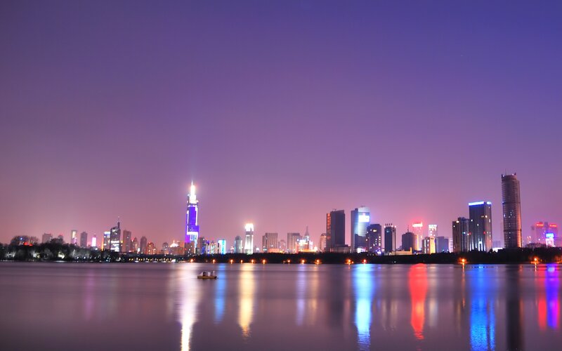 nighttime city skyline by the lake